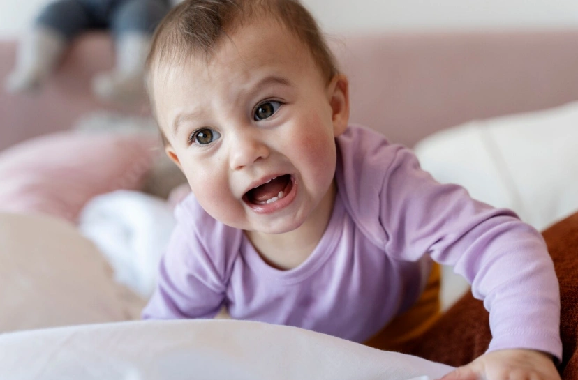 niedliches Baby, das auf dem Bett krabbelt