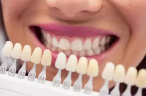 dentist examining female patient with teeth shades