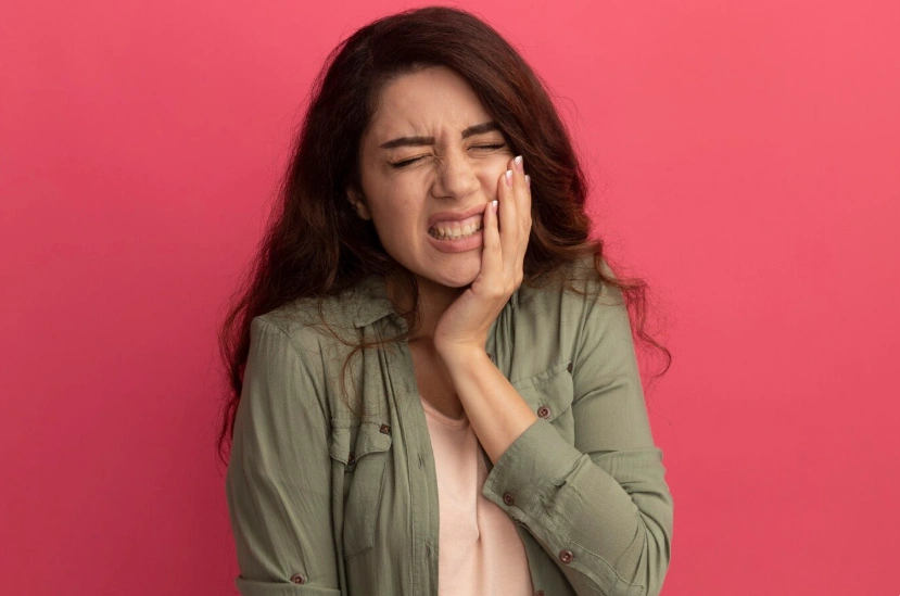 girl putting hand aching tooth