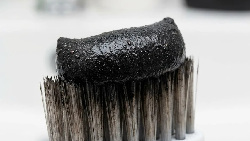 abrasive charcoal paste on bristles