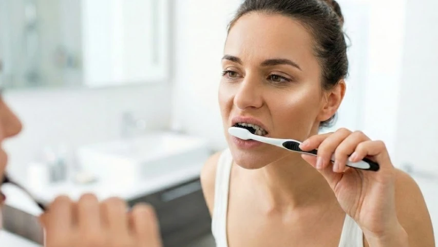 brushing with charcoal toothpaste