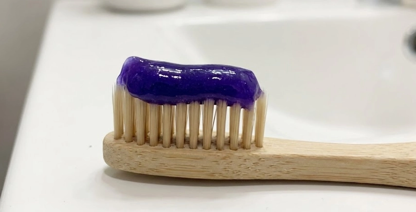 vibrant violet paste on a toothbrush