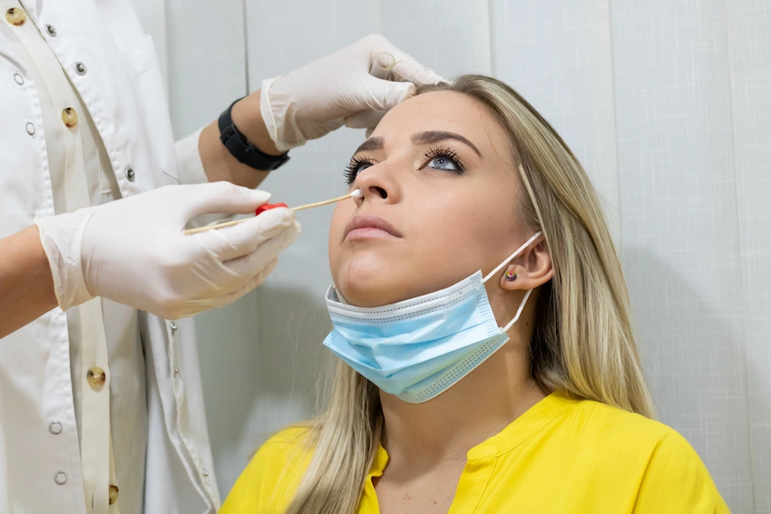 doctor administering nasal swab test
