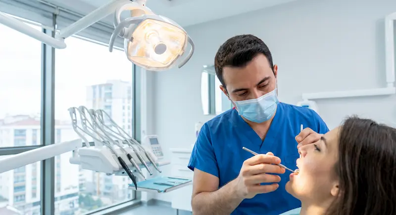 Dentist examines patient's teeth. Dentist examines patient's teeth.